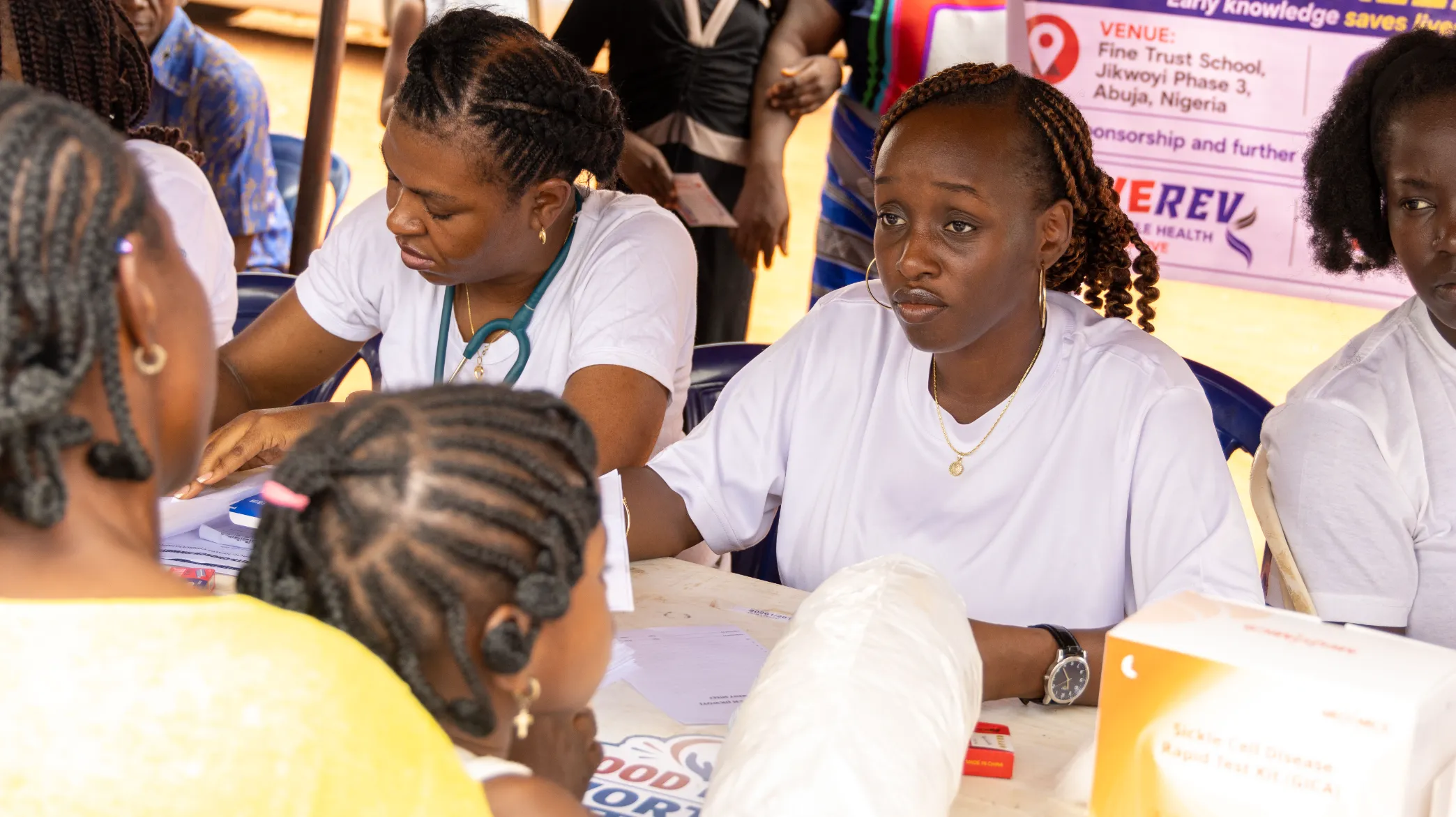 Health workers supporting genotype screening at a community outreach